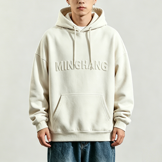 Front view of cream embossed hoodie with embossed letter