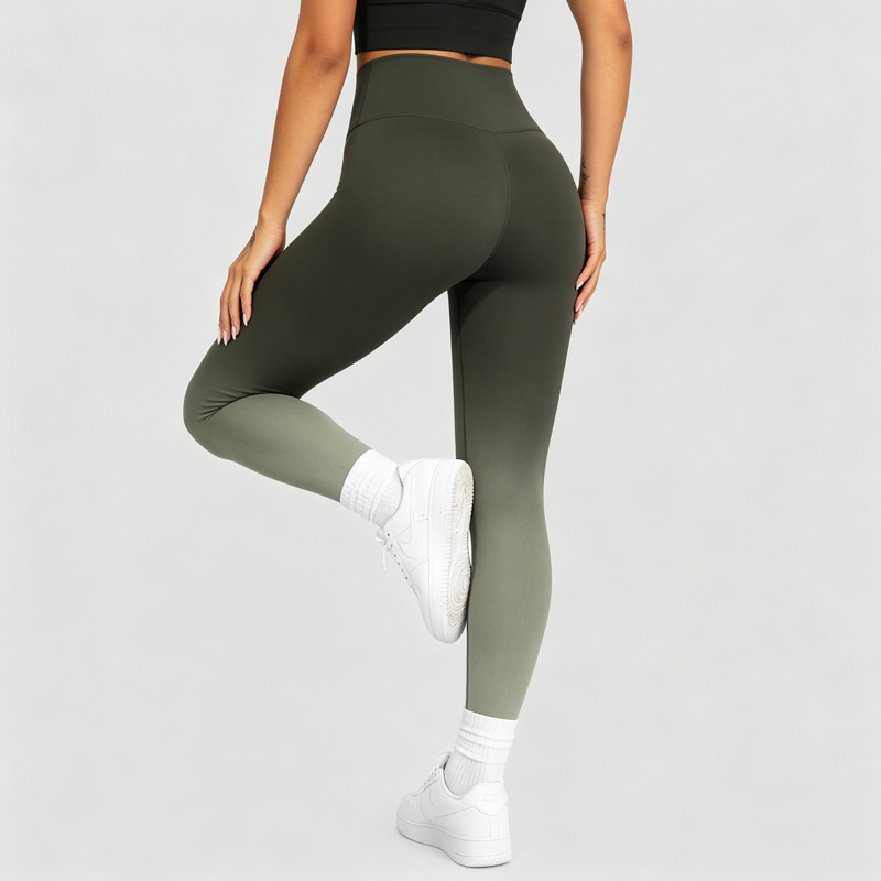 Back view of a woman balancing on one leg with the other knee raised, wearing olive green ombre leggings.