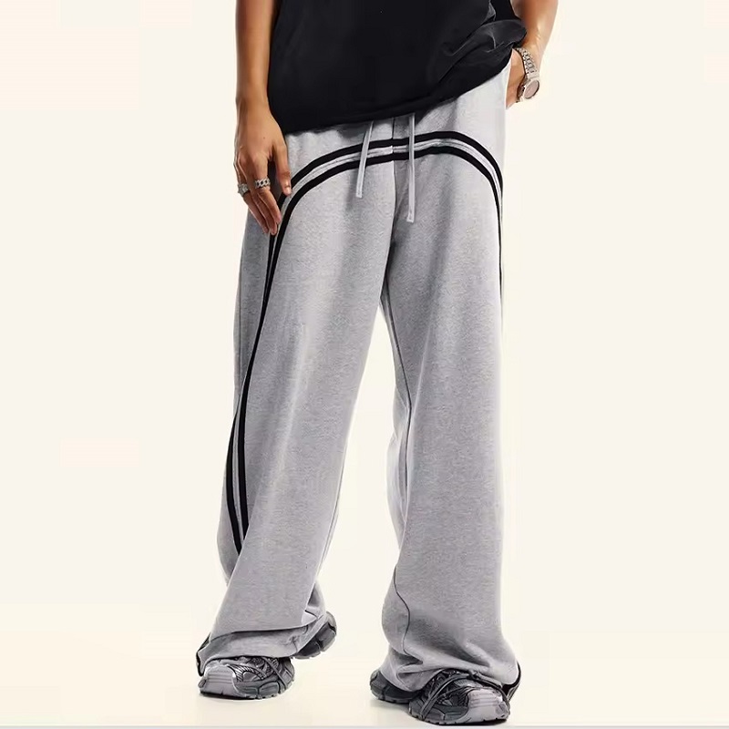 Men's light gray cotton fleece sweatpants with curved black side stripes, baggy wide-leg streetwear pants